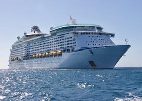A luxurious cruise ship sailing on the ocean under a clear blue sky, ideal for travel and leisure.